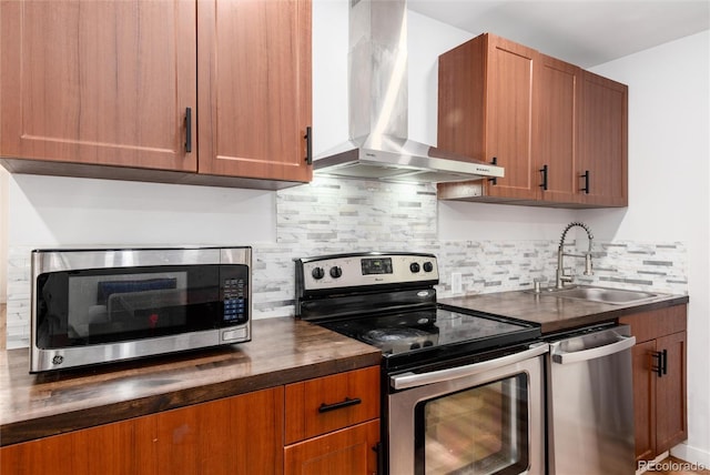 192 Little Creek Rd, Idaho Springs, CO 80452 - kitchen with appliances with stainless steel finishes, wall chimney exhaust hood, a sink, brown cabinetry, and tasteful backsplash