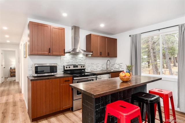 192 Little Creek Rd, Idaho Springs, CO 80452 - kitchen with wall chimney exhaust hood, appliances with stainless steel finishes, wood counters, light wood finished floors, and recessed lighting