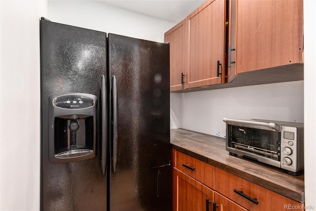 192 Little Creek Rd, Idaho Springs, CO 80452 - kitchen with black fridge, butcher block countertops, and brown cabinetry