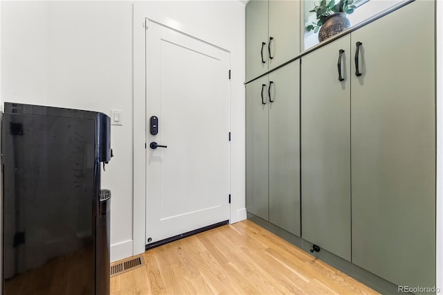 interior space featuring light wood finished floors and visible vents
