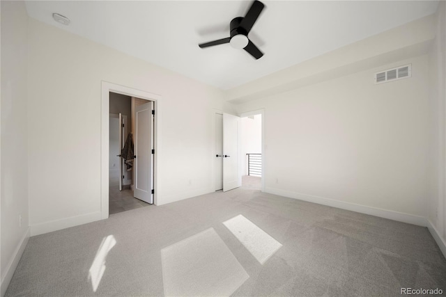 unfurnished bedroom with light colored carpet, baseboards, a ceiling fan, and visible vents