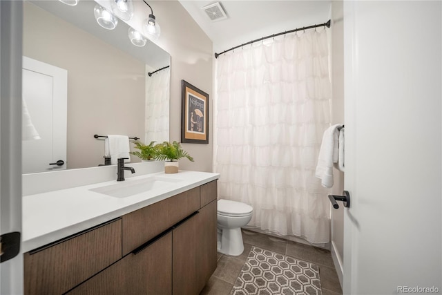 full bathroom featuring vanity, visible vents, toilet, curtained shower, and tile patterned floors