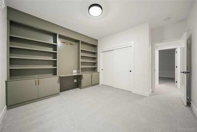 unfurnished bedroom featuring a closet, visible vents, light colored carpet, and baseboards