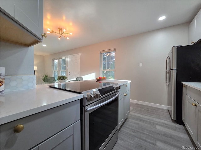 1250 S Monaco Pkwy Unit 17, Denver, CO 80224 - kitchen featuring stainless steel appliances, gray cabinetry, light wood-style flooring, light countertops, and recessed lighting