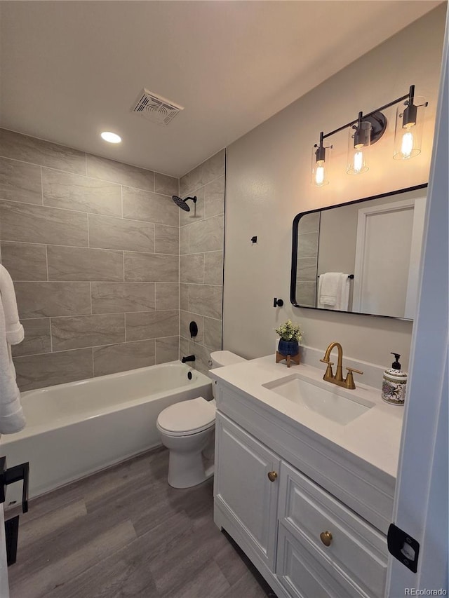 1250 S Monaco Pkwy Unit 17, Denver, CO 80224 - full bath with vanity, wood finished floors, bathtub / shower combination, toilet, and recessed lighting