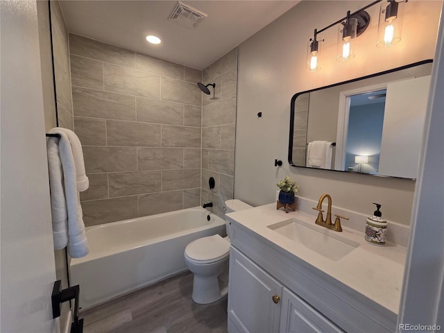 1250 S Monaco Pkwy Unit 17, Denver, CO 80224 - bathroom with wood finished floors, vanity, toilet, shower / tub combination, and recessed lighting