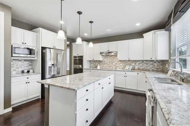 kitchen featuring decorative backsplash, stainless steel appliances, white cabinetry, sink, and dark hardwood / wood-style floors