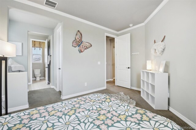 bedroom with ensuite bath, crown molding, and carpet floors