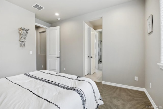 carpeted bedroom with ensuite bathroom