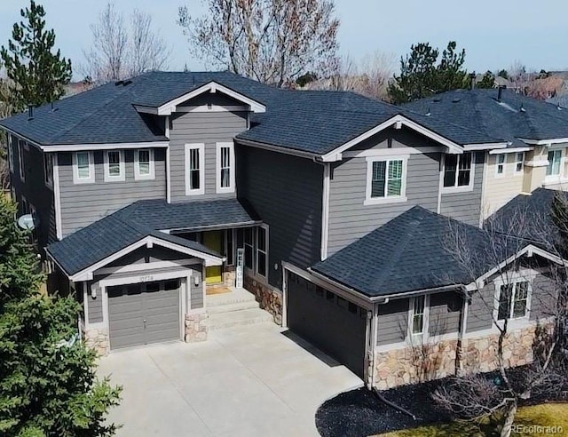 10774 Chadsworth Ln, Highlands Ranch, CO 80126 - view of front of house featuring stone siding, driveway, a shingled roof, and a garage