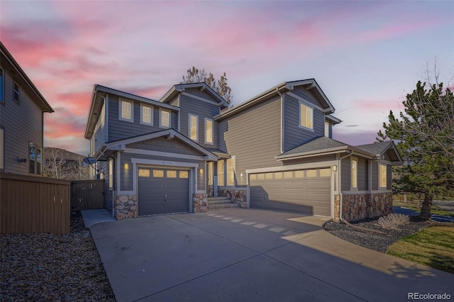 10774 Chadsworth Ln, Highlands Ranch, CO 80126 - view of front of home with stone siding, an attached garage, and driveway