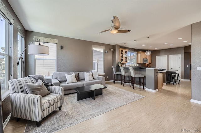 10774 Chadsworth Ln, Highlands Ranch, CO 80126 - living area with ceiling fan, light wood-style floors, recessed lighting, and baseboards