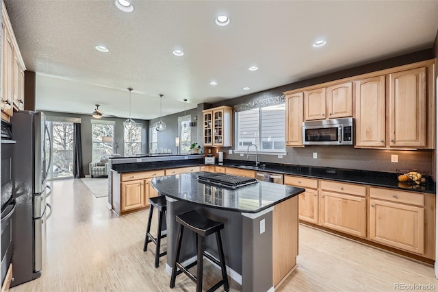 10774 Chadsworth Ln, Highlands Ranch, CO 80126 - kitchen featuring light brown cabinets, stainless steel appliances, a peninsula, a sink, and recessed lighting