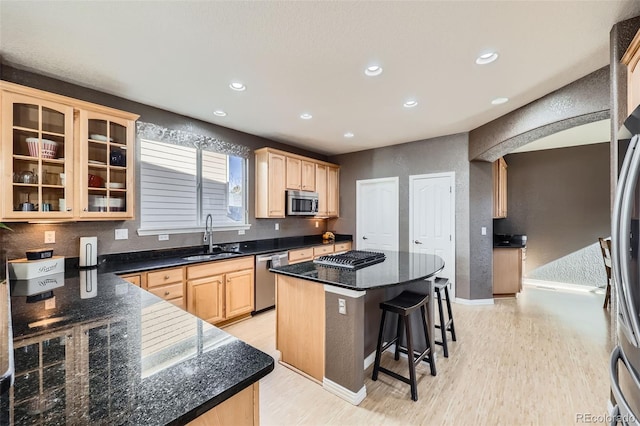 10774 Chadsworth Ln, Highlands Ranch, CO 80126 - kitchen with light brown cabinets, a sink, a breakfast bar, a kitchen island, and appliances with stainless steel finishes