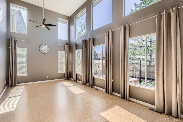 10774 Chadsworth Ln, Highlands Ranch, CO 80126 - spare room with ceiling fan, a towering ceiling, baseboards, and wood finished floors
