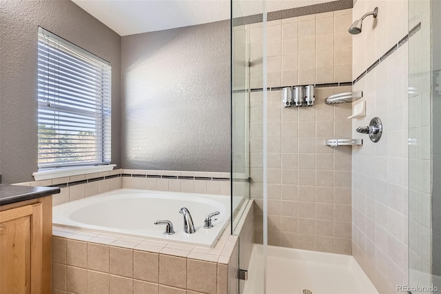 10774 Chadsworth Ln, Highlands Ranch, CO 80126 - full bath featuring a textured wall, a stall shower, a bath, and vanity