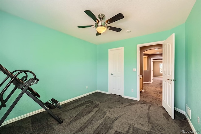 10774 Chadsworth Ln, Highlands Ranch, CO 80126 - unfurnished bedroom with dark colored carpet, baseboards, arched walkways, and ceiling fan