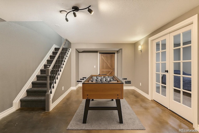 10774 Chadsworth Ln, Highlands Ranch, CO 80126 - recreation room featuring finished concrete flooring, french doors, baseboards, and a textured ceiling
