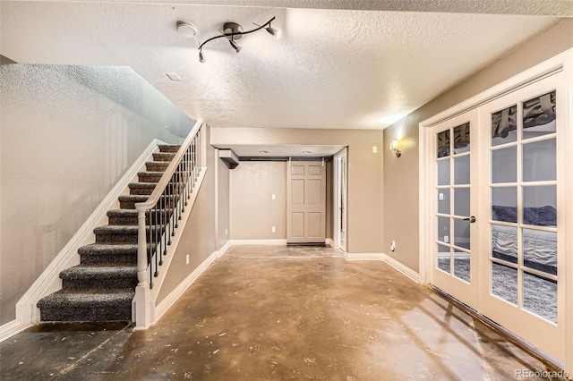 10774 Chadsworth Ln, Highlands Ranch, CO 80126 - foyer entrance featuring french doors, unfinished concrete flooring, stairs, baseboards, and a textured ceiling