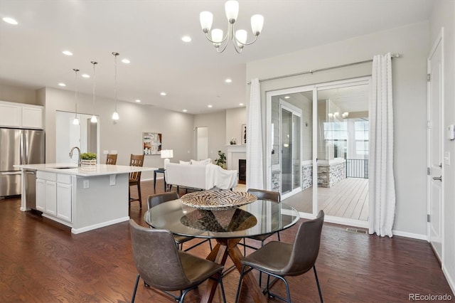 dining area featuring a notable chandelier, recessed lighting, baseboards, dark wood-type flooring, and visible vents
