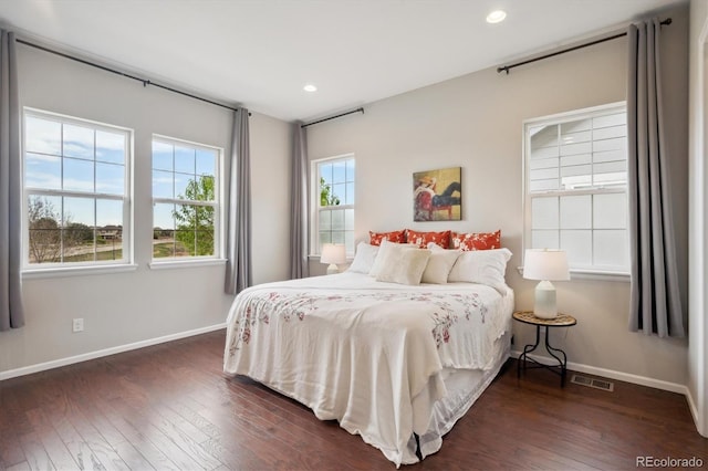 bedroom featuring dark wood-style flooring, baseboards, visible vents, and recessed lighting