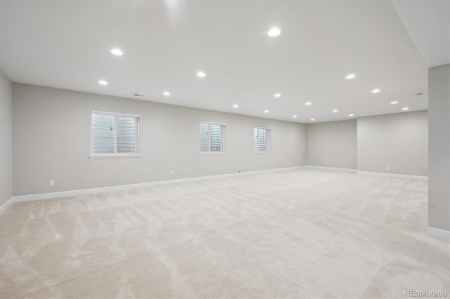 below grade area with baseboards, recessed lighting, and light carpet