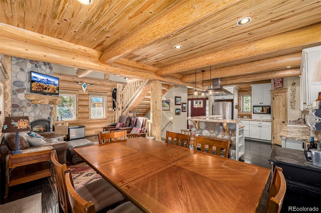 50 Pine St, Empire, CO 80438 - dining space with rustic walls, stairway, wood ceiling with exposed beams, recessed lighting, and dark wood-type flooring