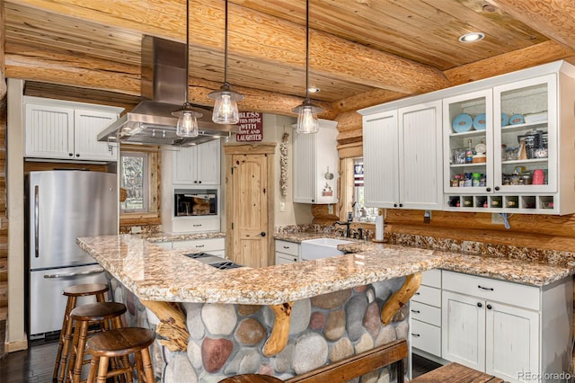 50 Pine St, Empire, CO 80438 - kitchen featuring freestanding refrigerator, island range hood, wooden ceiling with exposed beams, a kitchen bar, and a sink