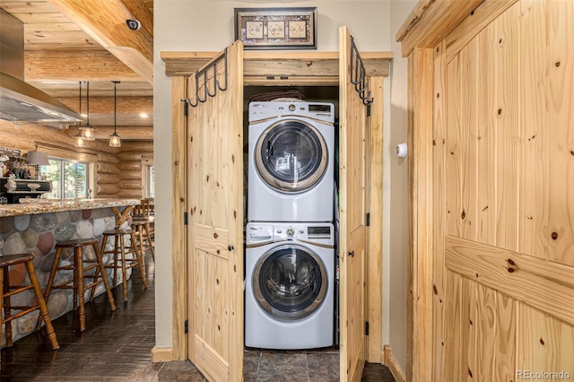 50 Pine St, Empire, CO 80438 - laundry room with stacked washer / drying machine and rustic walls