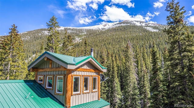 50 Pine St, Empire, CO 80438 - rear view of house with a wooded view, a mountain view, board and batten siding, and metal roof