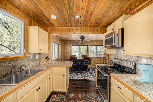 50 Pine St, Empire, CO 80438 - kitchen with stainless steel appliances, wood ceiling, dark wood-style flooring, a sink, and tile countertops