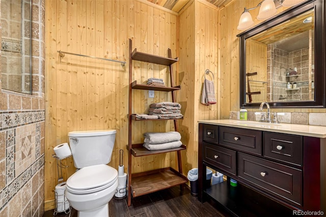 50 Pine St, Empire, CO 80438 - bathroom featuring vanity, wood finished floors, toilet, and wooden walls
