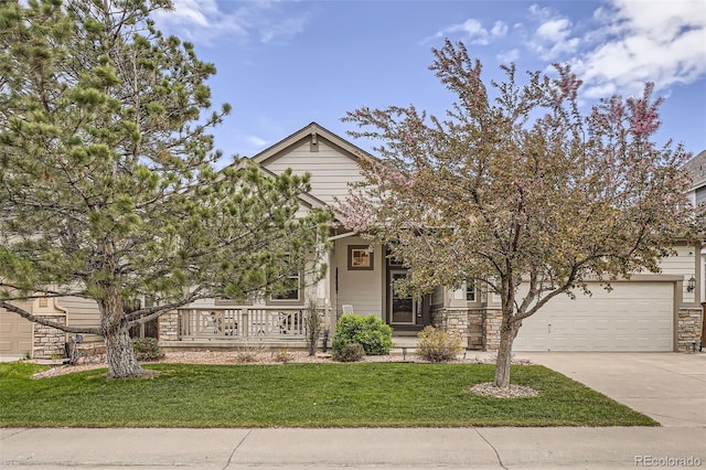 obstructed view of property featuring concrete driveway, a porch, a front lawn, and stone siding