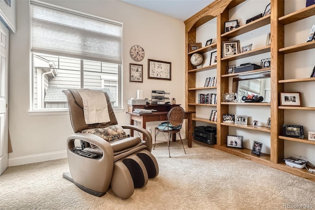 living area with a desk, carpet flooring, and baseboards