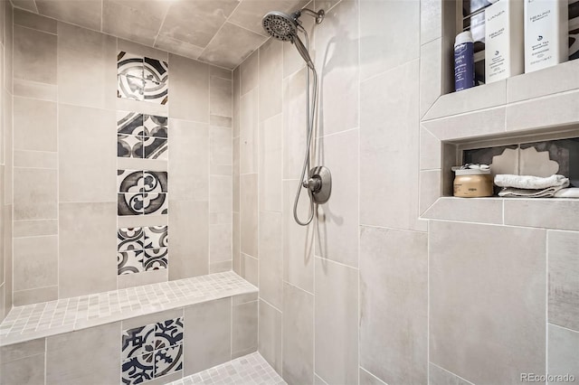 bathroom with a tile shower