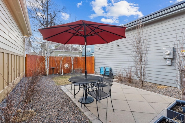 view of patio with outdoor dining space and a fenced backyard