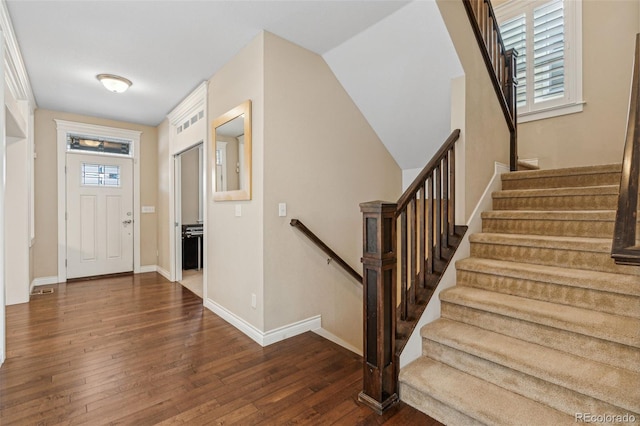 entryway with a healthy amount of sunlight, wood-type flooring, and baseboards