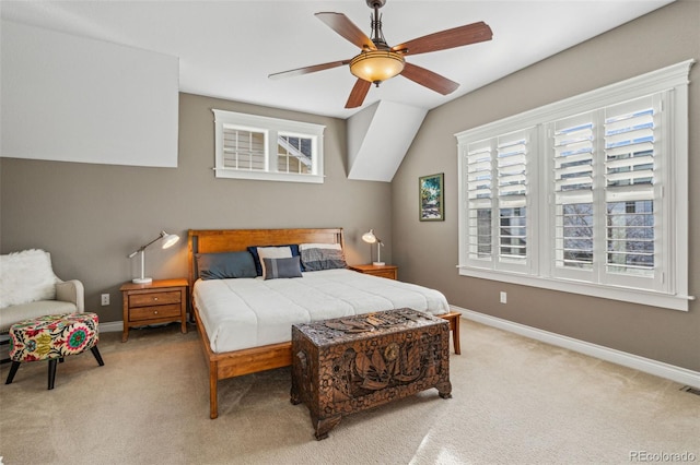 carpeted bedroom featuring multiple windows, baseboards, and a ceiling fan