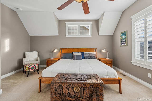 bedroom with visible vents, a ceiling fan, light carpet, vaulted ceiling, and baseboards