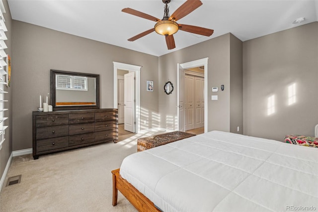 carpeted bedroom featuring visible vents, ceiling fan, and baseboards