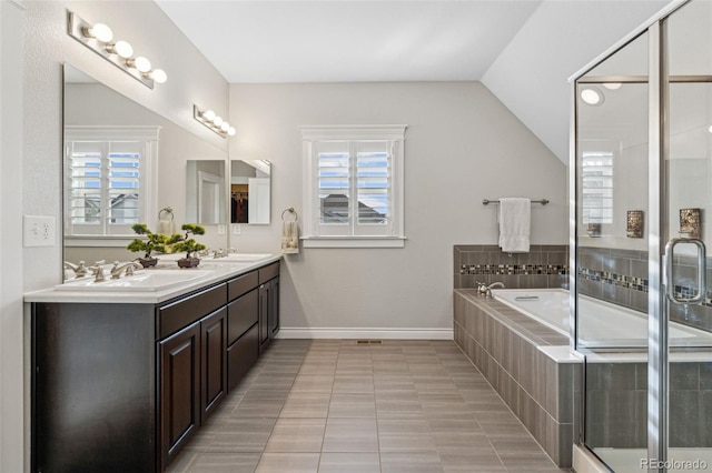 full bath with vaulted ceiling, a stall shower, a sink, and a healthy amount of sunlight