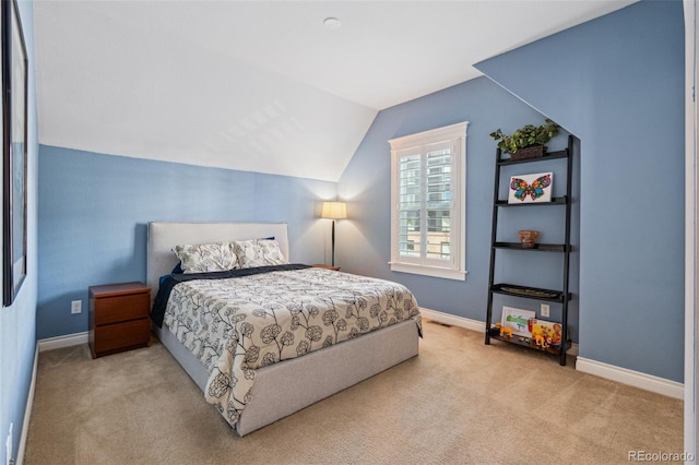 carpeted bedroom with vaulted ceiling and baseboards