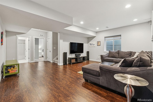 living room with visible vents, baseboards, wood finished floors, stairs, and recessed lighting