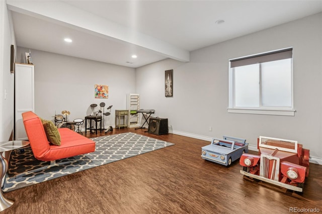 recreation room with recessed lighting, beam ceiling, baseboards, and wood finished floors