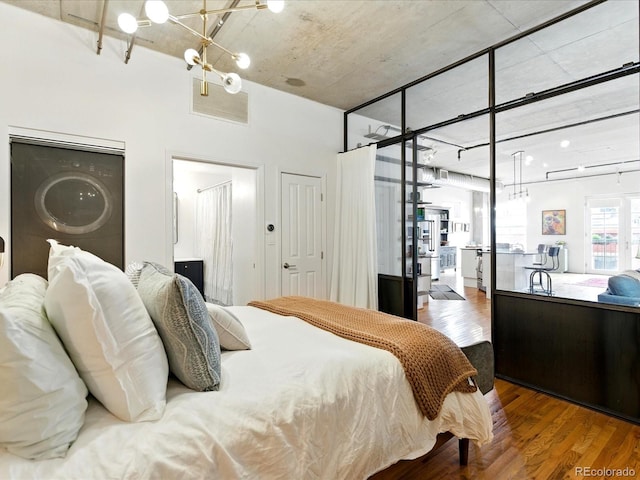 1499 Blake St Unit 3U, Denver, CO 80202 - bedroom featuring a chandelier and wood finished floors