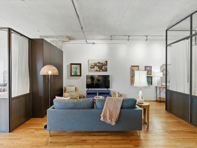 1499 Blake St Unit 3U, Denver, CO 80202 - living area featuring wood finished floors and track lighting