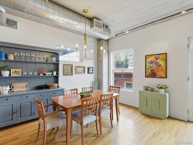 1499 Blake St Unit 3U, Denver, CO 80202 - dining room with light wood finished floors and a chandelier