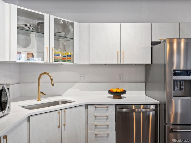 1499 Blake St Unit 3U, Denver, CO 80202 - kitchen with appliances with stainless steel finishes, a sink, and light countertops