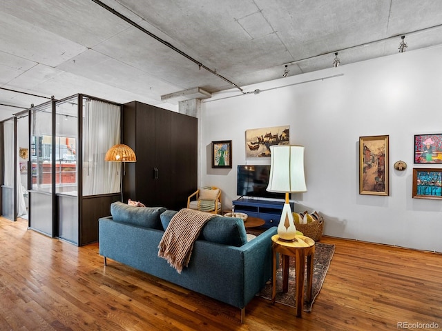 1499 Blake St Unit 3U, Denver, CO 80202 - living room featuring wood finished floors and track lighting