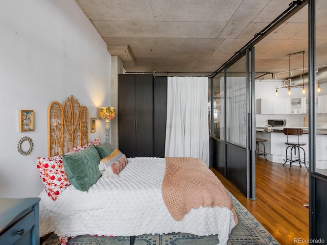 1499 Blake St Unit 3U, Denver, CO 80202 - bedroom with wood finished floors
